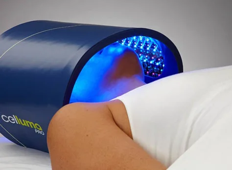 A guest beneath an LED light therapy panel.