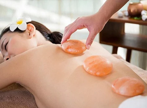 Himalayan salt stones placed on the back during a massage.